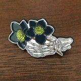 Skeleton holding Black Hellebore Enamel Pin